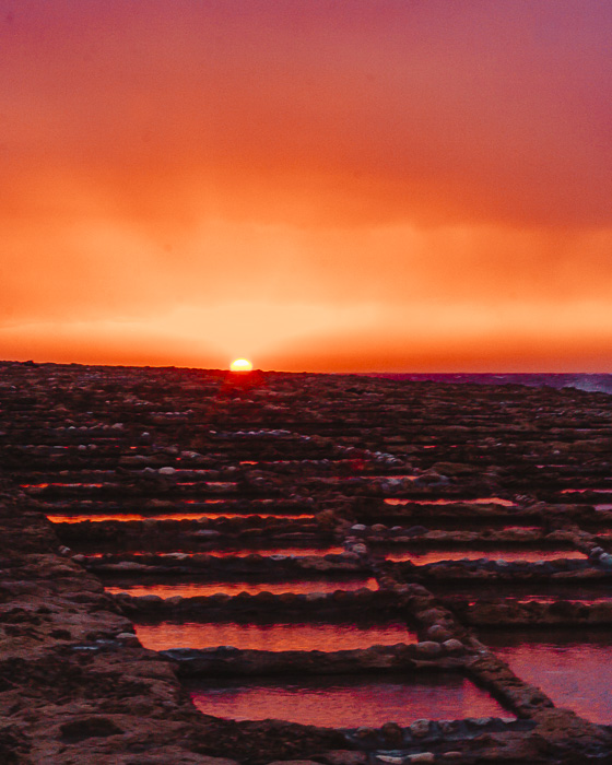 Malta travel guide Gozo island Ghajn Barrani salt pans at sunset by Dancing the Earth