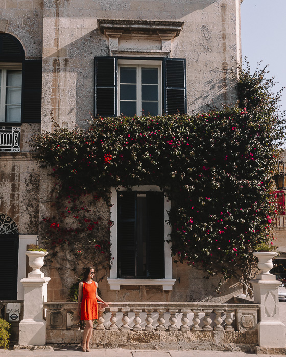 Old house with blue windows and flowers in Mdina by Dancing the Earth