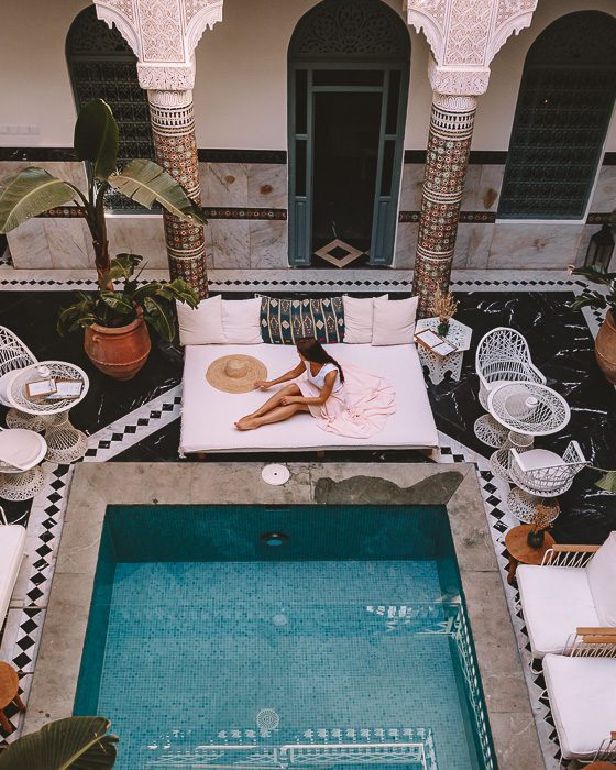 Relaxing on the sun lounger near the pool of riad Ksar Kasbah in Marrakesh by Dancing the Earth