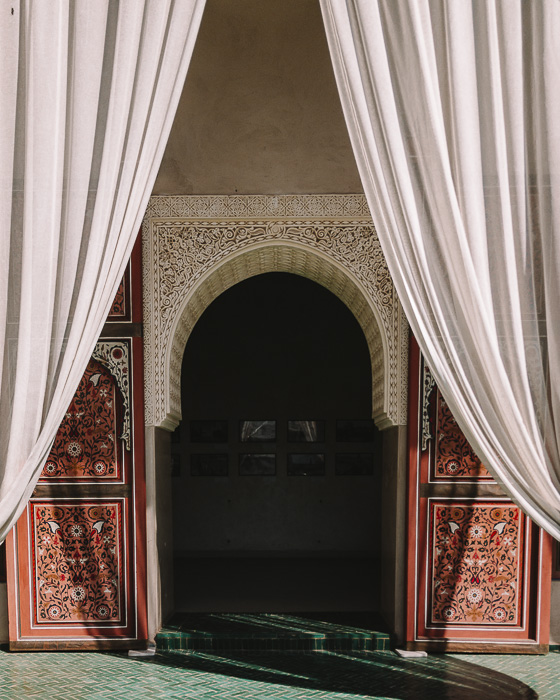 A door framed with curtains in the secret garden of Marrakesh by Dancing the Earth