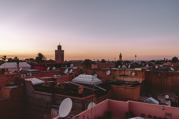 Morocco travel guide sun setting over Marrakesh from riad Ksar Kasbah by Dancing the Earth