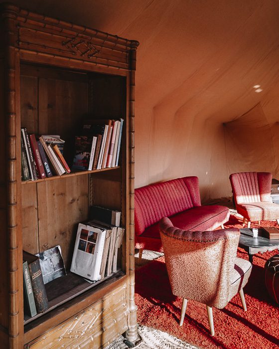 Bookshelves in the living room tent of Scarabeo Camp by Dancing the Earth