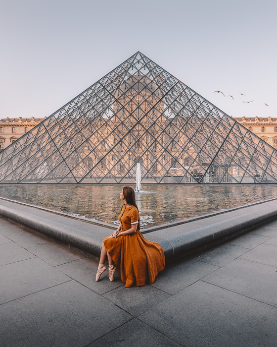 Sitting on the side of the Louvre pyramid by Dancing the Earth