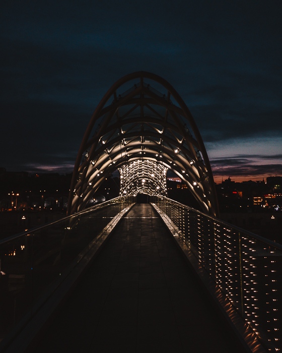 Tbilisi Peace Bridge by night by Dancing the Earth