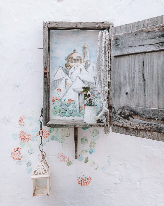 Locorotondo's wall drawing with a wooden window frame