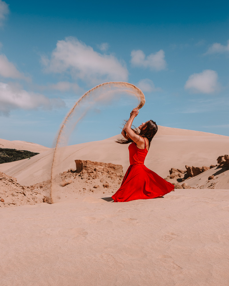 Throwing sand in Te Paki sand dunes, Dancing the Earth