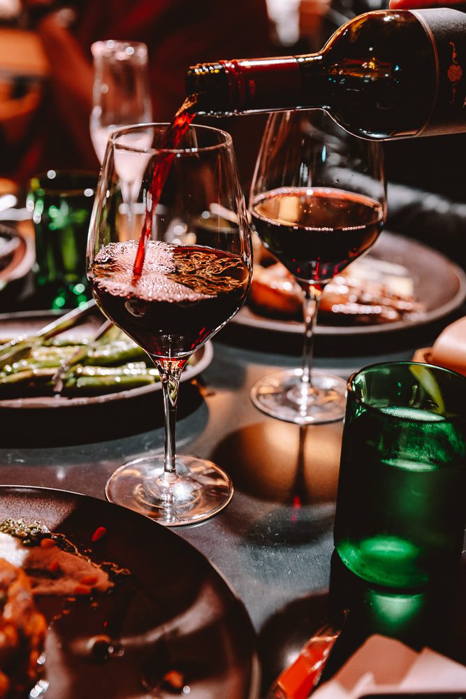 Wine being poured at Midtown Grill restaurant, by Dancing The Earth