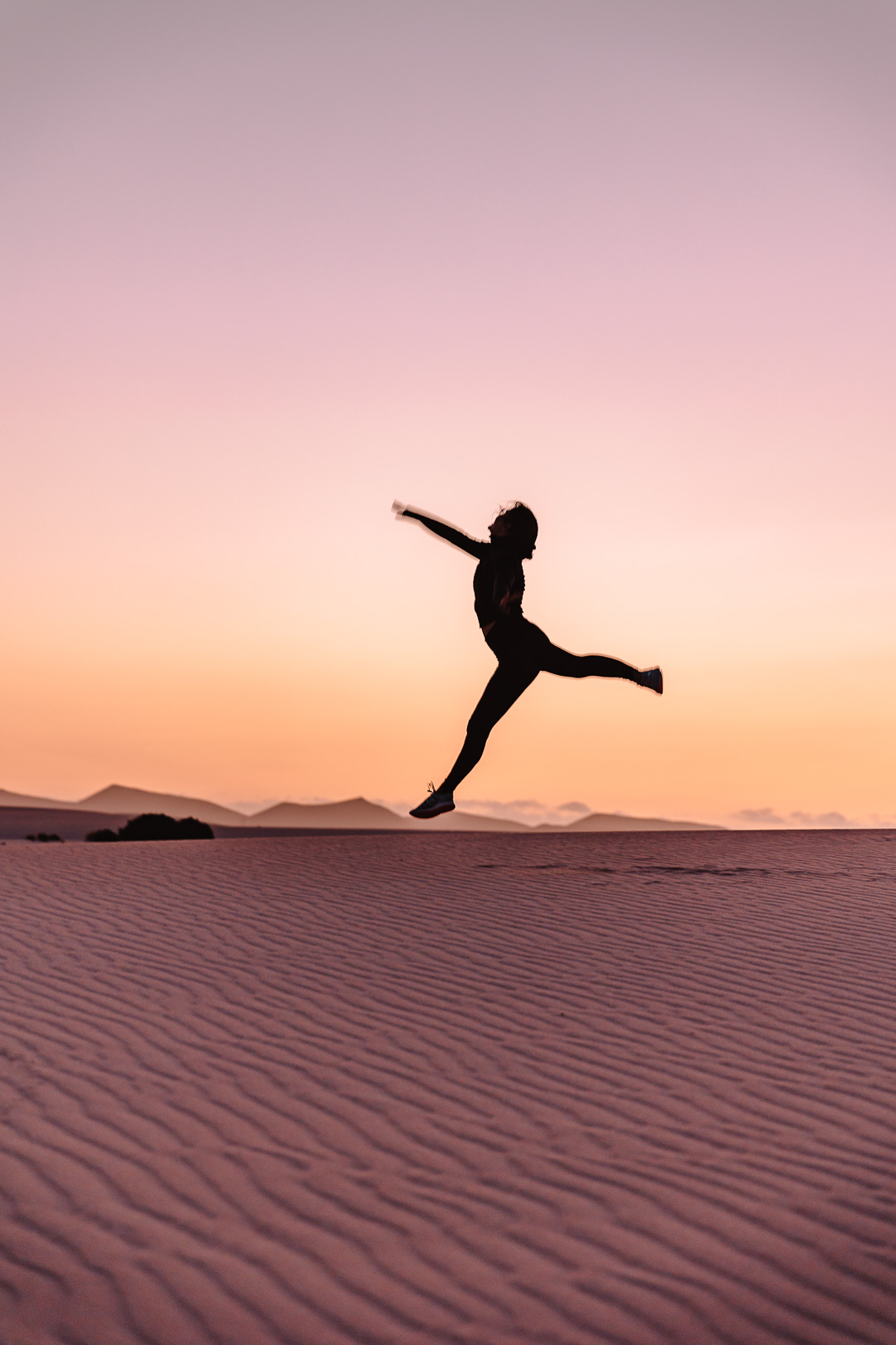 Jumping at sunset on the dunes of Corralejo, by Dancing the Earth