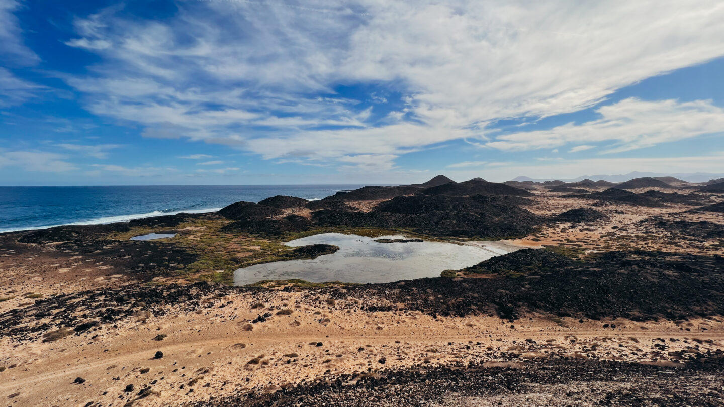 Ocean, green lake and volcanoes on Lobos Island, by Dancing the Earth